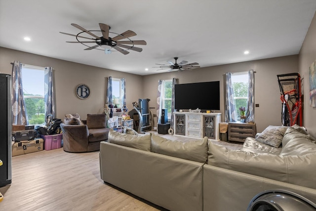 living area featuring recessed lighting, a ceiling fan, and light wood finished floors