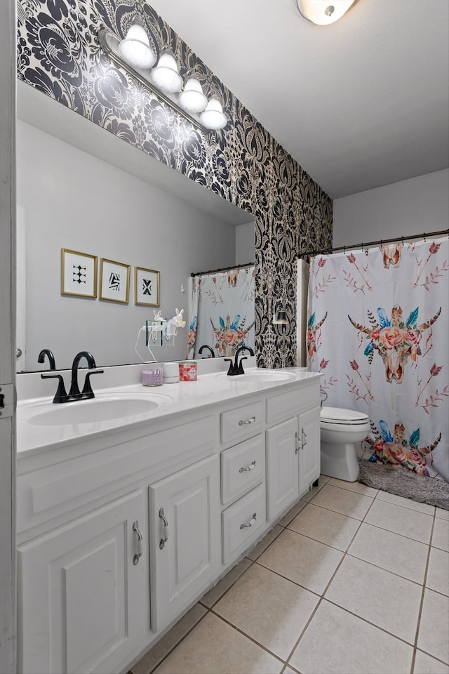 bathroom featuring wallpapered walls, double vanity, toilet, tile patterned floors, and a shower with shower curtain