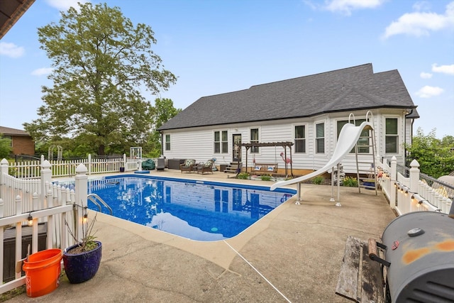 view of pool with a water slide, an outdoor living space, a patio, and a pergola