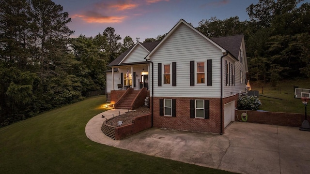 view of front of home featuring stairway, brick siding, concrete driveway, an attached garage, and a patio
