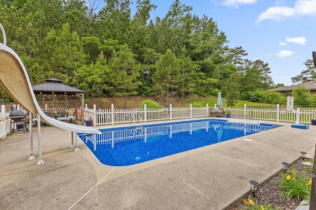 view of pool with a water slide, a gazebo, and a patio