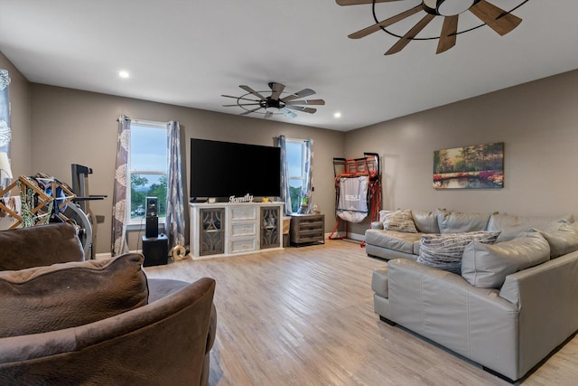 living room with ceiling fan, light wood-style flooring, recessed lighting, and baseboards