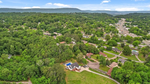 aerial overview of property's location featuring a forest and mountains
