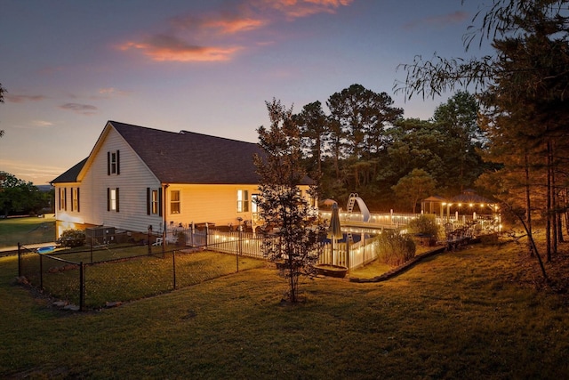 back of property at dusk with roof with shingles
