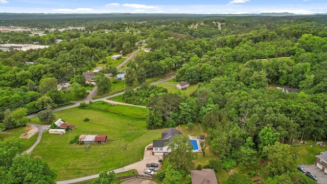 aerial view of property's location featuring a forest