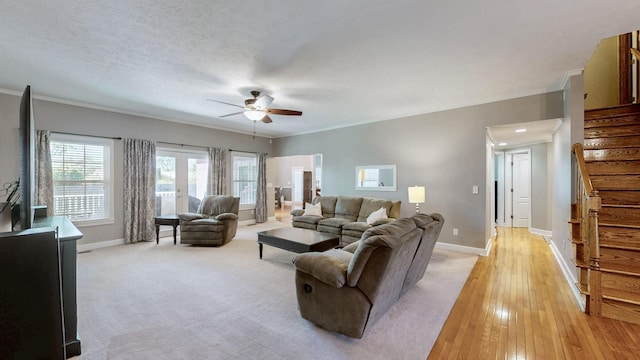 203 Ha Le Koa Ct, Smyrna, TN 37167 - living area featuring a ceiling fan, stairway, baseboards, crown molding, and light wood-style flooring