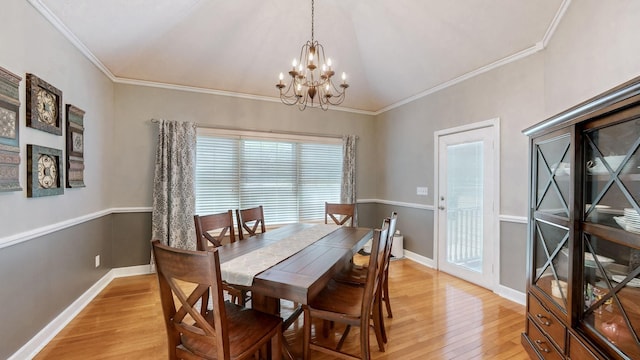 203 Ha Le Koa Ct, Smyrna, TN 37167 - dining space with light wood finished floors, a chandelier, baseboards, ornamental molding, and lofted ceiling