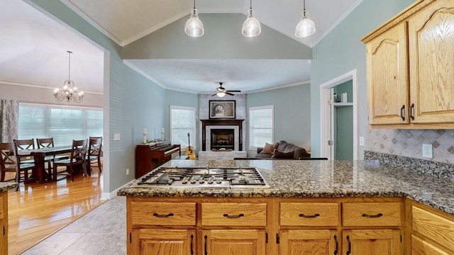 203 Ha Le Koa Ct, Smyrna, TN 37167 - kitchen featuring stainless steel gas stovetop, a ceiling fan, a peninsula, dark stone counters, and vaulted ceiling