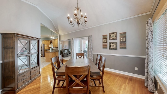 203 Ha Le Koa Ct, Smyrna, TN 37167 - dining area featuring a chandelier, lofted ceiling, light wood finished floors, crown molding, and baseboards