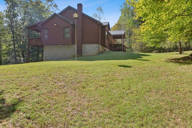 4455 Tarsus Rd, Palmyra, TN 37142 - view of property exterior with a lawn, log veneer siding, and a chimney