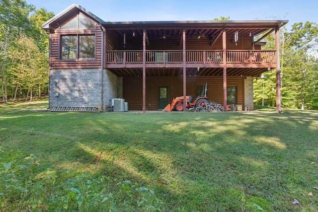 4455 Tarsus Rd, Palmyra, TN 37142 - rear view of property featuring a lawn, a deck, central AC, and log veneer siding