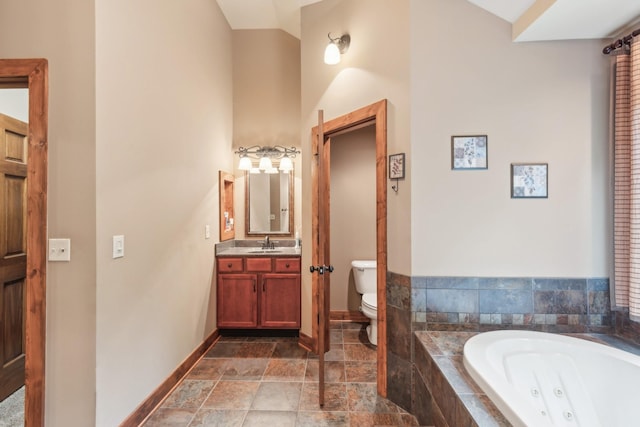 4455 Tarsus Rd, Palmyra, TN 37142 - bathroom with a jetted tub, toilet, baseboards, vanity, and stone finish flooring