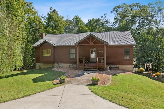 4455 Tarsus Rd, Palmyra, TN 37142 - view of front of property with a chimney, a porch, a front yard, and metal roof