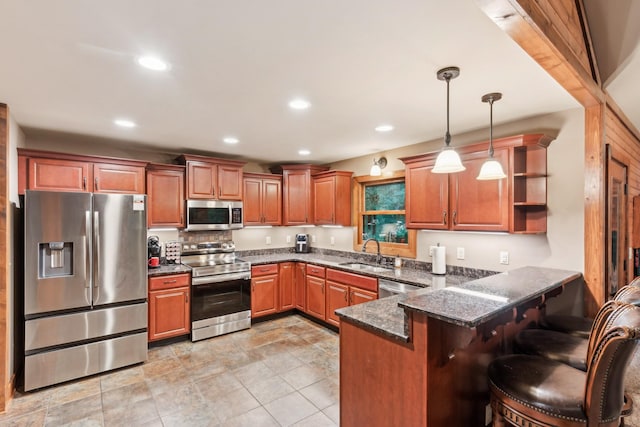 4455 Tarsus Rd, Palmyra, TN 37142 - kitchen with stainless steel appliances, a sink, a peninsula, hanging light fixtures, and brown cabinetry