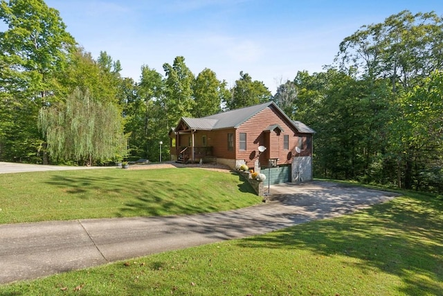 4455 Tarsus Rd, Palmyra, TN 37142 - cabin with a garage, concrete driveway, a front yard, and metal roof