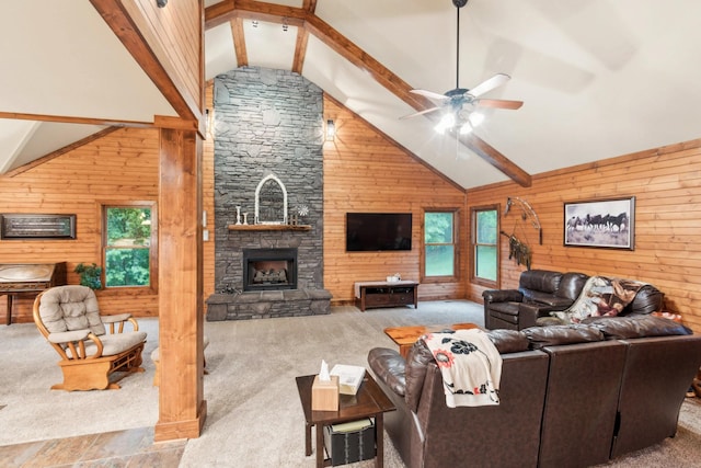 4455 Tarsus Rd, Palmyra, TN 37142 - carpeted living area with wooden walls, plenty of natural light, a ceiling fan, and a stone fireplace