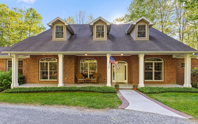 2385 Clear Brooks Dr, Signal Mountain, TN 37377 - cape cod-style house featuring brick siding, a porch, a front lawn, and a shingled roof