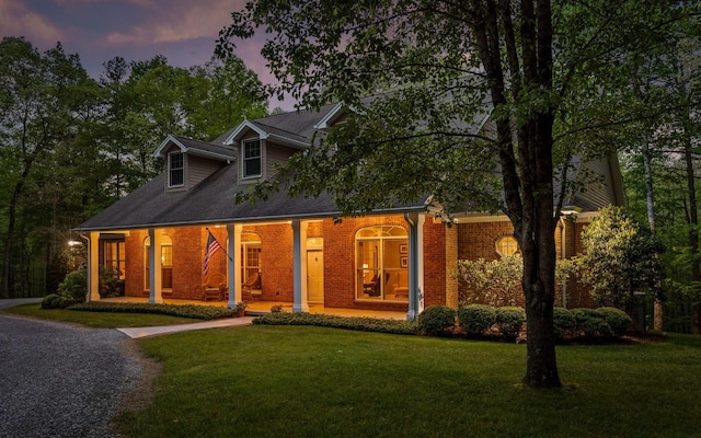 2385 Clear Brooks Dr, Signal Mountain, TN 37377 - cape cod house featuring a porch, brick siding, and a front lawn