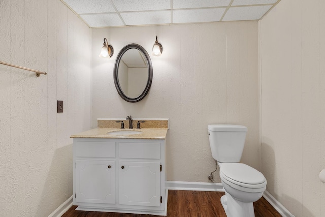 1107 Gardner Dr, Franklin, TN 37064 - half bath with toilet, wood finished floors, a paneled ceiling, vanity, and baseboards