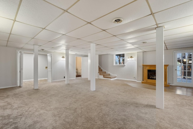 1107 Gardner Dr, Franklin, TN 37064 - below grade area with carpet flooring, stairs, a drop ceiling, a fireplace with raised hearth, and baseboards
