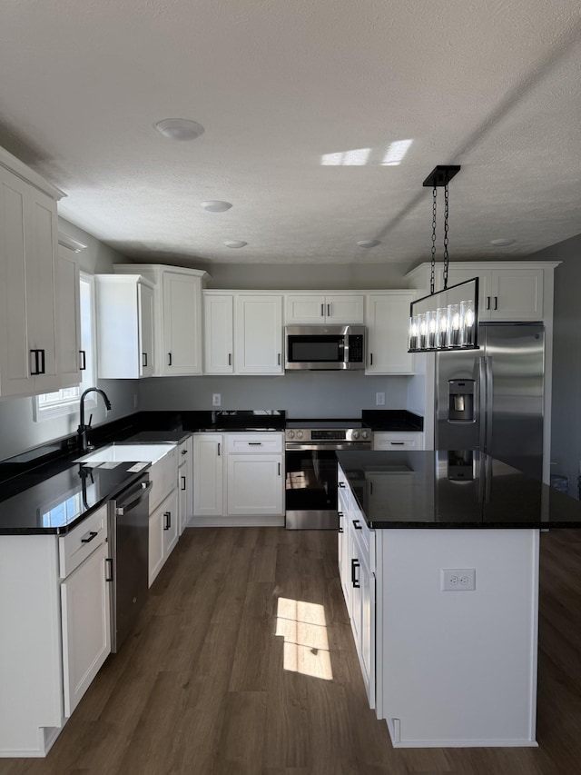 1331 Springplace Rd, Lewisburg, TN 37091 - kitchen with stainless steel appliances, dark countertops, dark wood-style floors, white cabinets, and a textured ceiling