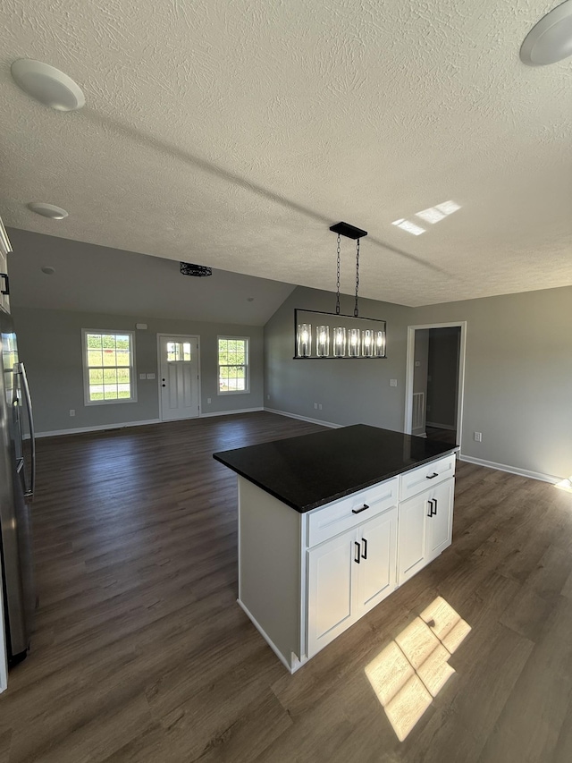 1331 Springplace Rd, Lewisburg, TN 37091 - kitchen featuring dark countertops, a textured ceiling, dark wood finished floors, open floor plan, and white cabinets