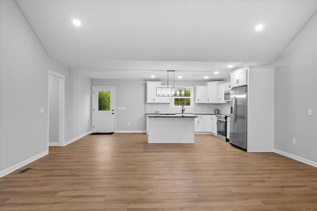 1331 Springplace Rd, Lewisburg, TN 37091 - kitchen featuring stainless steel appliances, open floor plan, recessed lighting, white cabinetry, and light wood finished floors