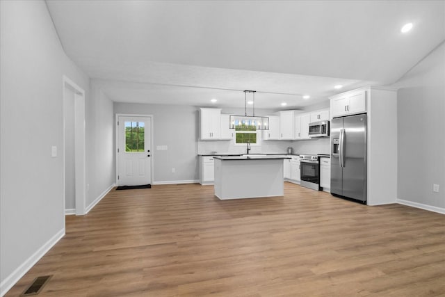 1331 Springplace Rd, Lewisburg, TN 37091 - kitchen with appliances with stainless steel finishes, recessed lighting, plenty of natural light, white cabinetry, and a kitchen island