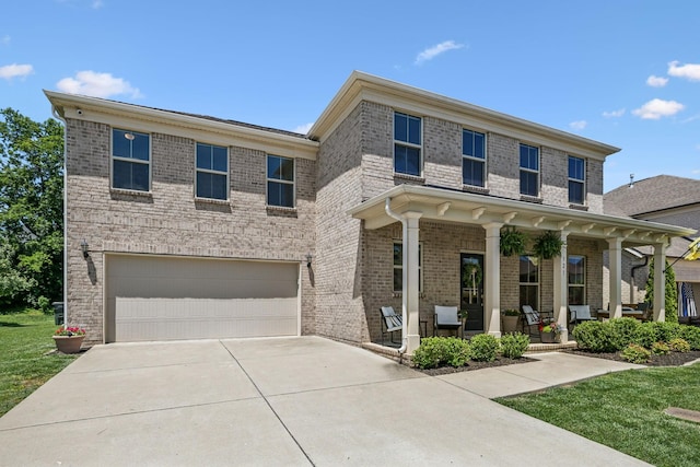 321 Union Pier Dr, Mount Juliet, TN 37122 - view of front of home featuring a porch, an attached garage, brick siding, driveway, and a front lawn