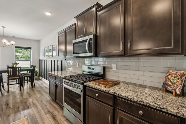 321 Union Pier Dr, Mount Juliet, TN 37122 - kitchen with appliances with stainless steel finishes, backsplash, light stone countertops, and light wood-type flooring
