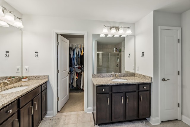 321 Union Pier Dr, Mount Juliet, TN 37122 - full bathroom with a shower stall, two vanities, a walk in closet, baseboards, and tile patterned flooring
