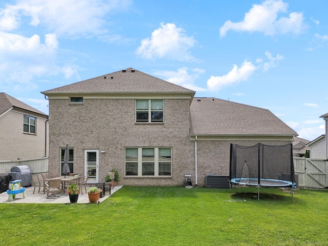 321 Union Pier Dr, Mount Juliet, TN 37122 - back of house with a patio area, brick siding, a trampoline, and a shingled roof