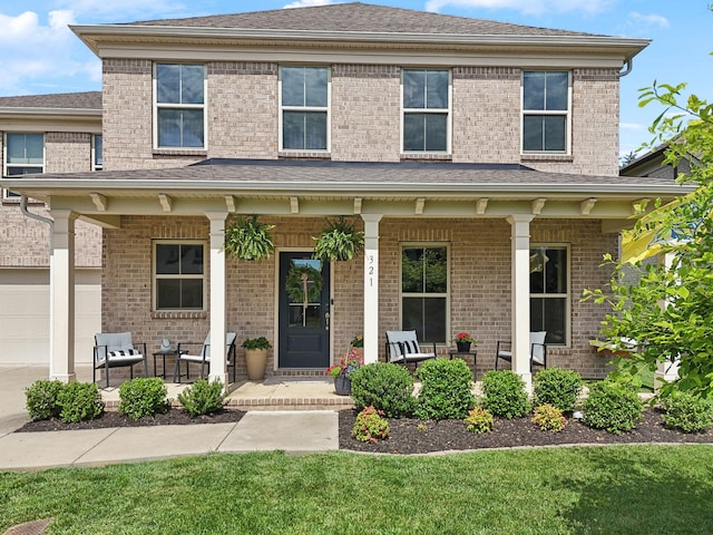 321 Union Pier Dr, Mount Juliet, TN 37122 - view of front of home with covered porch, a garage, and brick siding