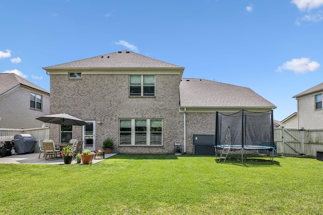 321 Union Pier Dr, Mount Juliet, TN 37122 - rear view of house featuring a patio, a trampoline, brick siding, and a shingled roof