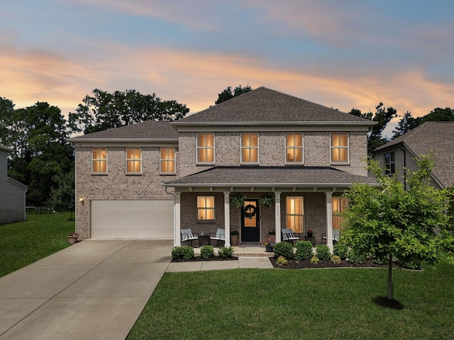 321 Union Pier Dr, Mount Juliet, TN 37122 - view of front facade with covered porch, concrete driveway, an attached garage, a front yard, and brick siding