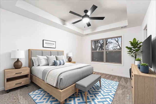 27 Sevier St, Clarksville, TN 37042 - bedroom featuring a raised ceiling, dark colored carpet, baseboards, and a ceiling fan