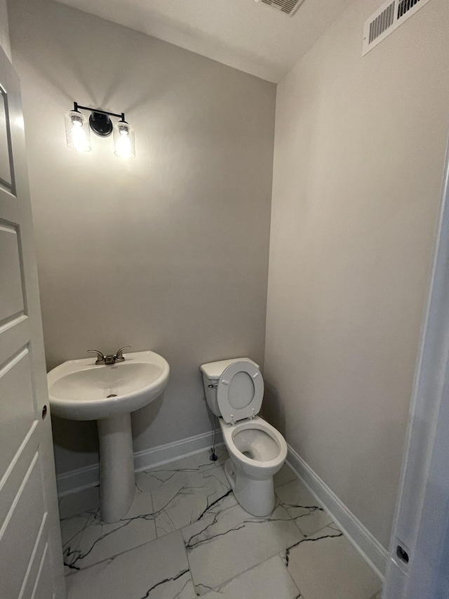 53 Charleston Cv, Clarksville, TN 37043 - half bathroom featuring marble finish floors and toilet