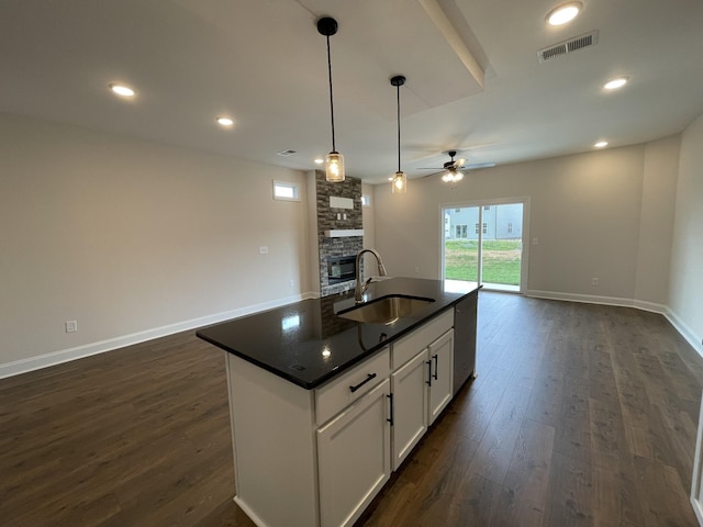 53 Charleston Cv, Clarksville, TN 37043 - kitchen with a fireplace, dark countertops, ceiling fan, open floor plan, and dark wood-style flooring