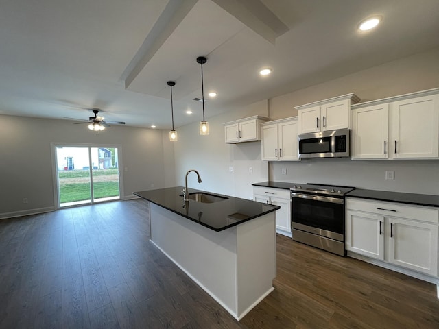 53 Charleston Cv, Clarksville, TN 37043 - kitchen with appliances with stainless steel finishes, dark countertops, ceiling fan, white cabinetry, and recessed lighting