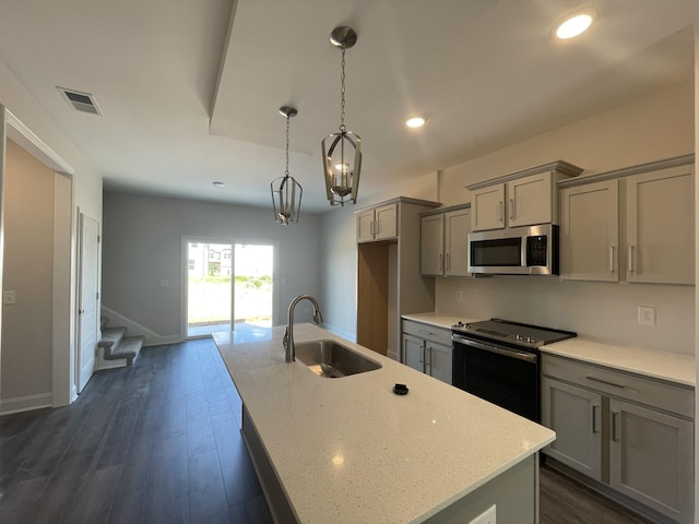 54 Charleston Cv, Clarksville, TN 37043 - kitchen featuring appliances with stainless steel finishes, gray cabinets, a kitchen island with sink, dark wood-style flooring, and recessed lighting