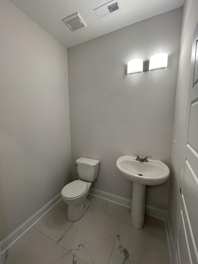 54 Charleston Cv, Clarksville, TN 37043 - half bathroom featuring marble look tile flooring and toilet