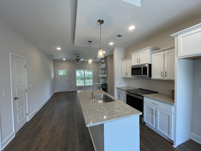 57 Charleston Cv, Clarksville, TN 37043 - kitchen with stainless steel appliances, dark wood finished floors, white cabinetry, ceiling fan, and recessed lighting