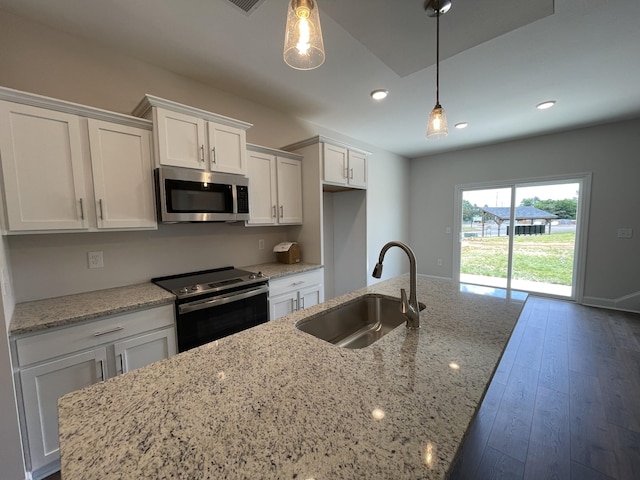 57 Charleston Cv, Clarksville, TN 37043 - kitchen with appliances with stainless steel finishes, white cabinetry, a kitchen island with sink, recessed lighting, and light stone counters