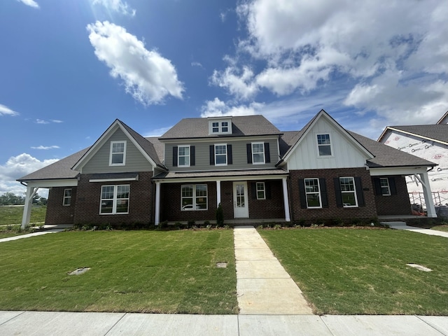 1075 Wrights Mill Rd Unit Arb066, Spring Hill, TN 37174 - view of front of home with covered porch, brick siding, a front yard, and board and batten siding