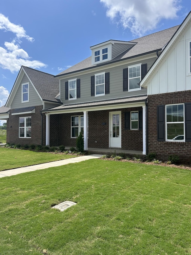 1075 Wrights Mill Rd Unit Arb066, Spring Hill, TN 37174 - view of front of house featuring brick siding, a front lawn, and a porch