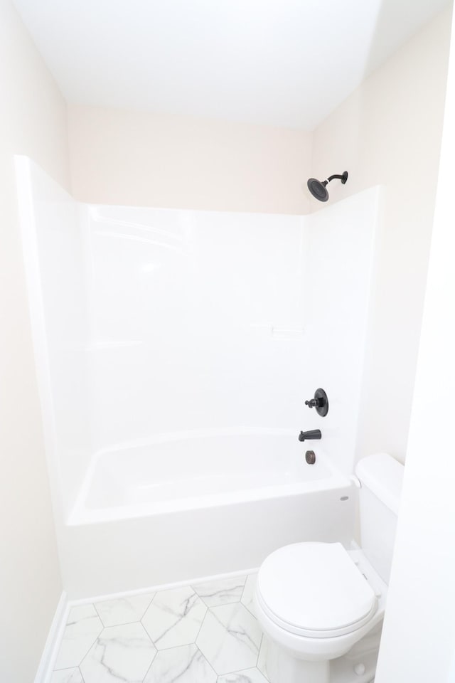 10172 Galen Rd, Lafayette, TN 37083 - bathroom featuring toilet, marble look tiles, and shower / washtub combination