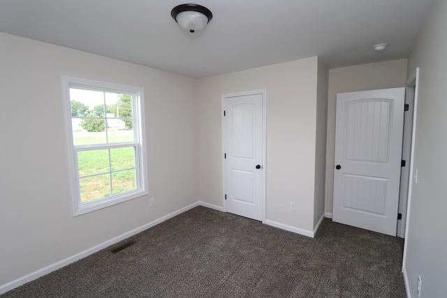 10172 Galen Rd, Lafayette, TN 37083 - unfurnished bedroom featuring dark carpet and baseboards