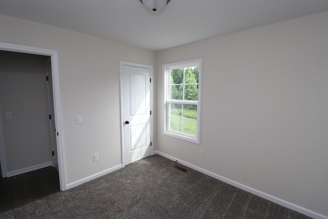 10172 Galen Rd, Lafayette, TN 37083 - unfurnished bedroom with dark colored carpet and baseboards