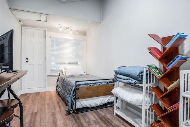 105 W Walnut St, Smithville, TN 37166 - bedroom featuring wood finished floors, attic access, and track lighting