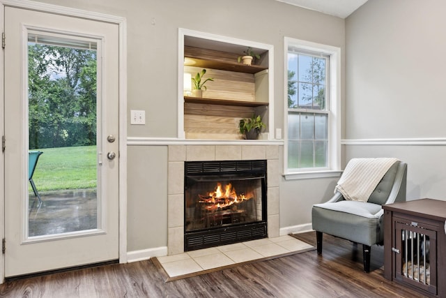 2236 Kim Dr, Clarksville, TN 37043 - living area featuring a tile fireplace, wood finished floors, and healthy amount of natural light